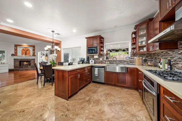 a kitchen with stainless steel appliances granite countertop a stove a sink dishwasher and a refrigerator