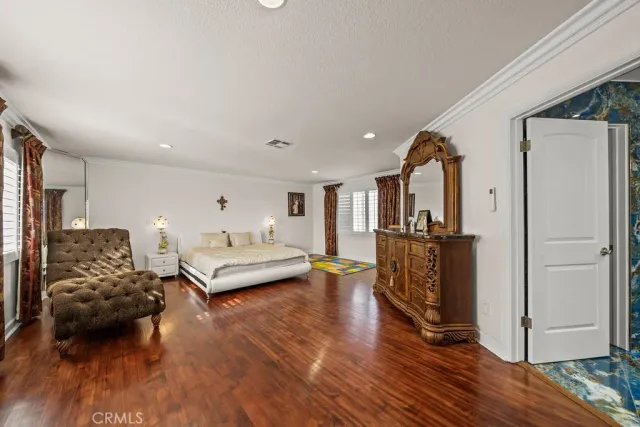 a living room with furniture and a table with wooden floor