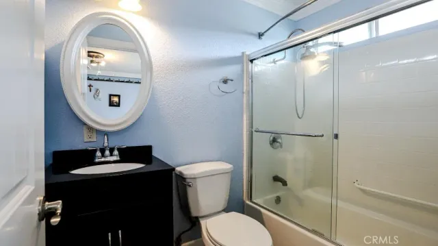 a bathroom with a toilet a sink and a mirror
