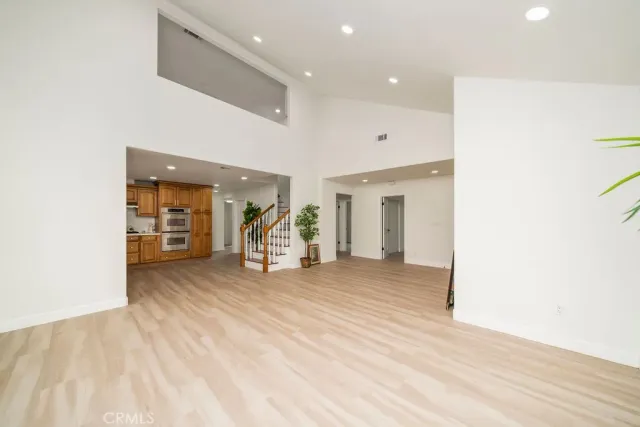 a view of a livingroom with wooden floor and a ceiling fan