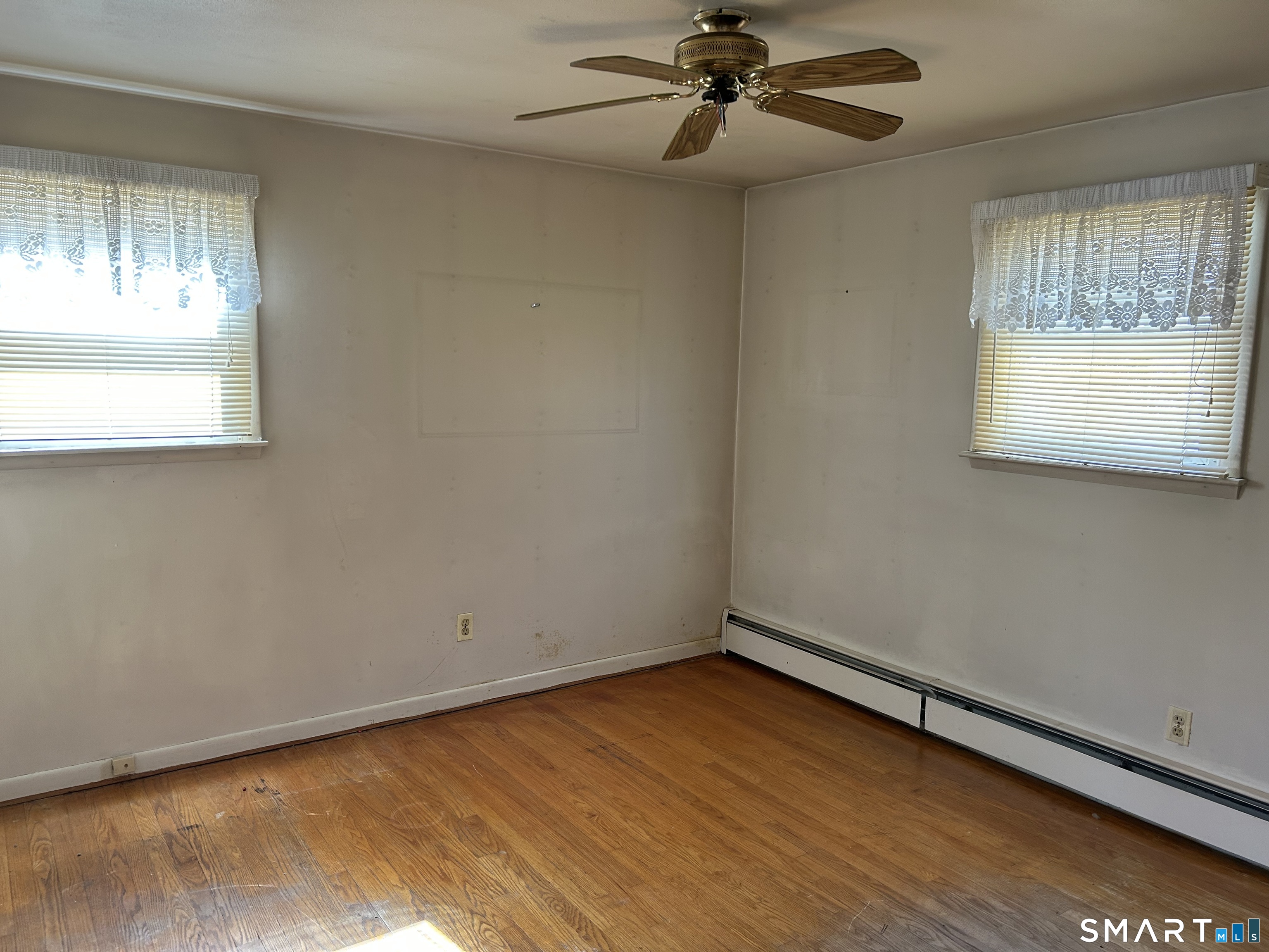 783 Buddington Road Groton, CT 06340 - Photo 19 of 35 an empty room with a window and a ceiling fan