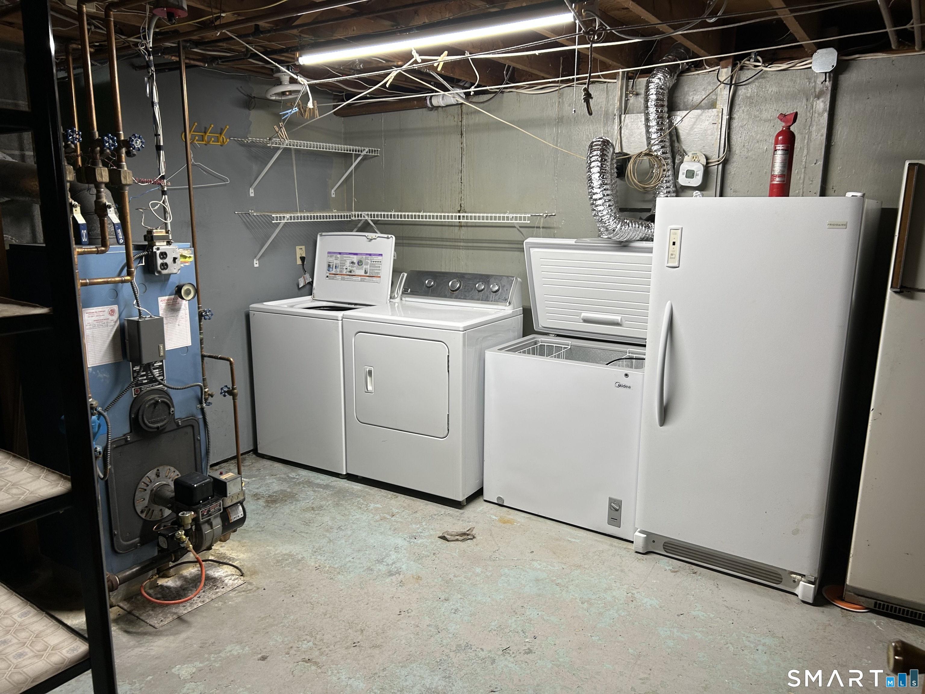 783 Buddington Road Groton, CT 06340 - Photo 27 of 35 a view of storage and utility room with washer and dryer