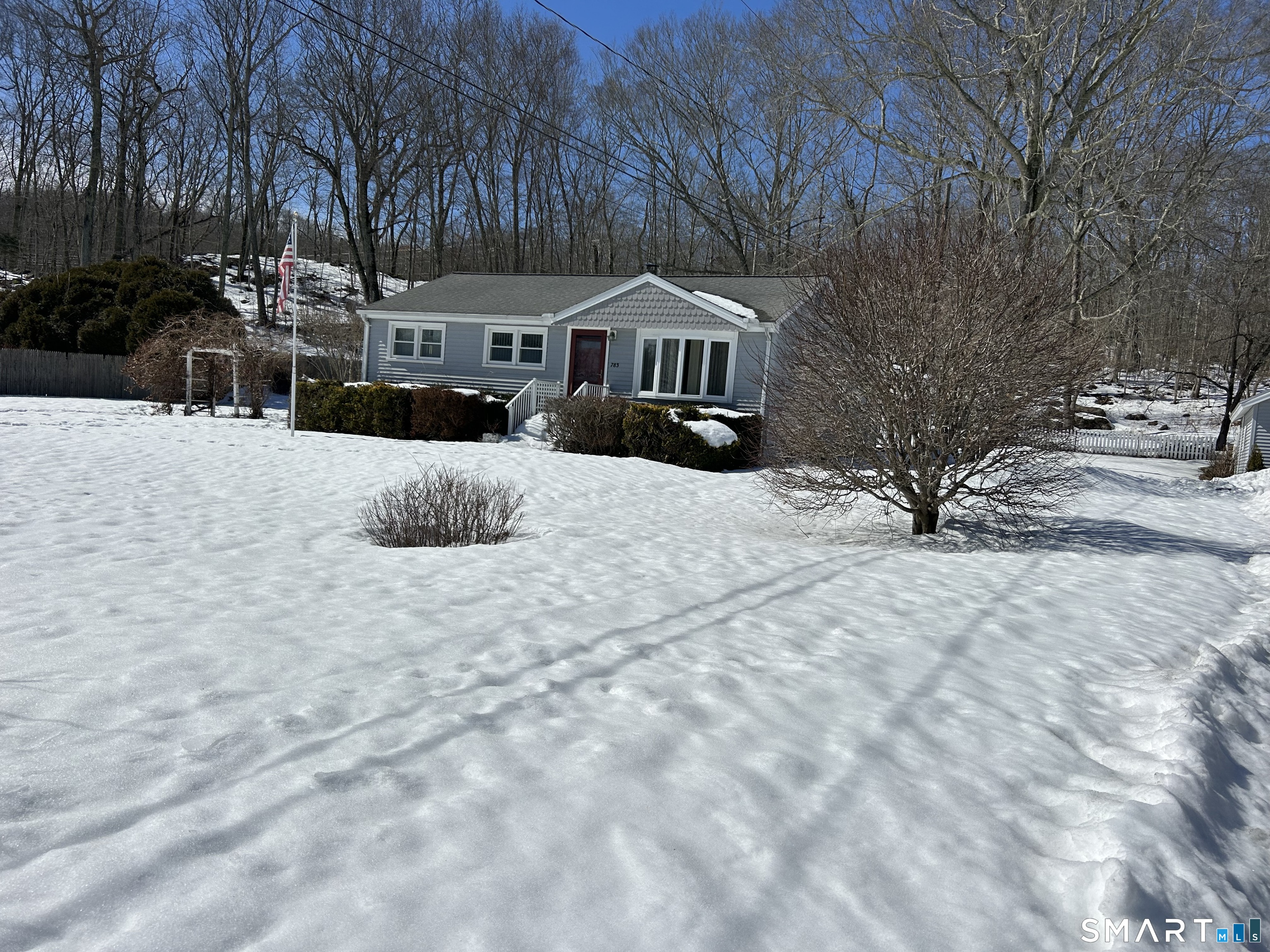 783 Buddington Road Groton, CT 06340 - Photo 5 of 35 a front view of a house with a yard covered in snow