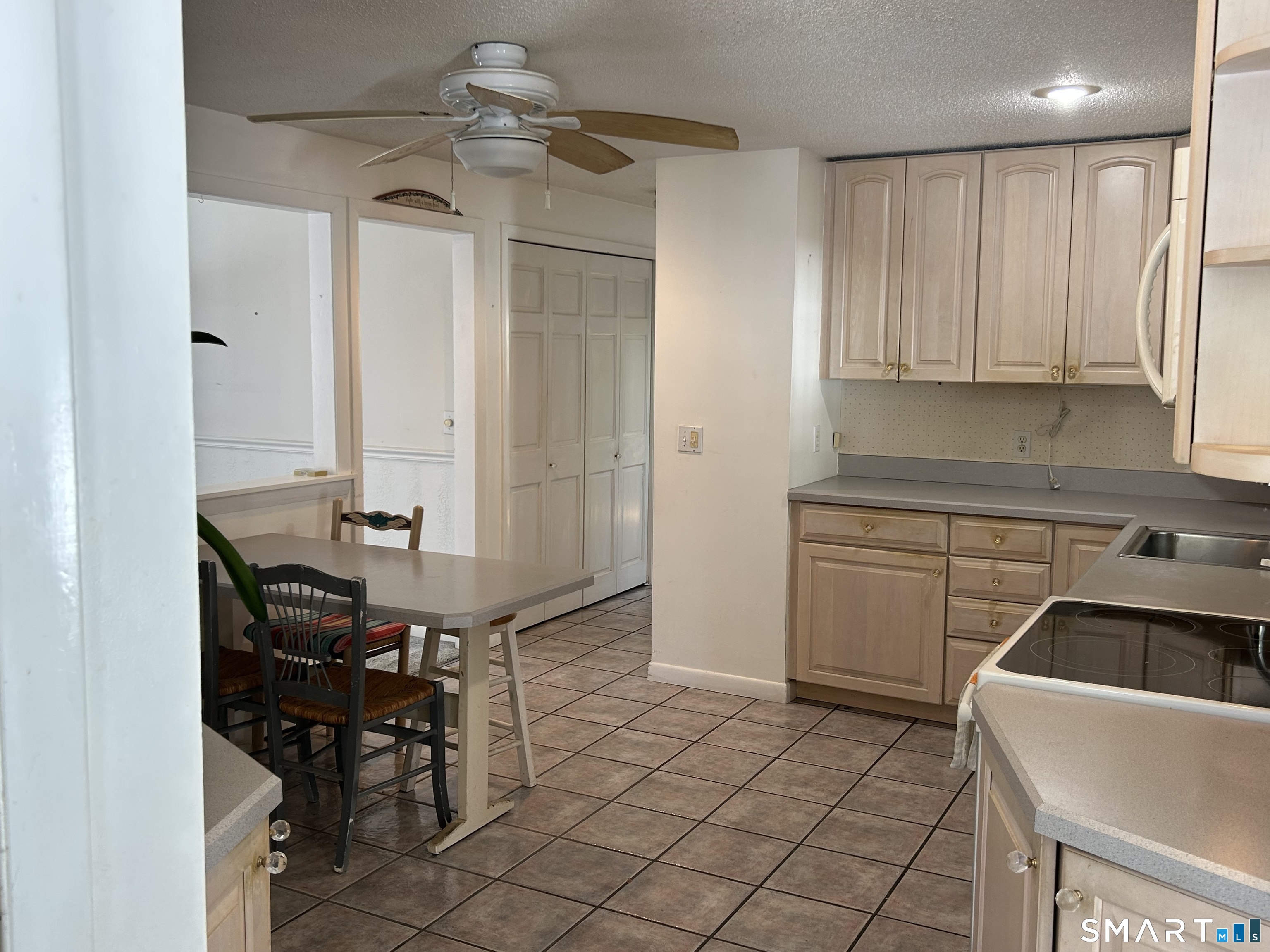 783 Buddington Road Groton, CT 06340 - Photo 10 of 35 a kitchen with stainless steel appliances granite countertop a sink and a refrigerator
