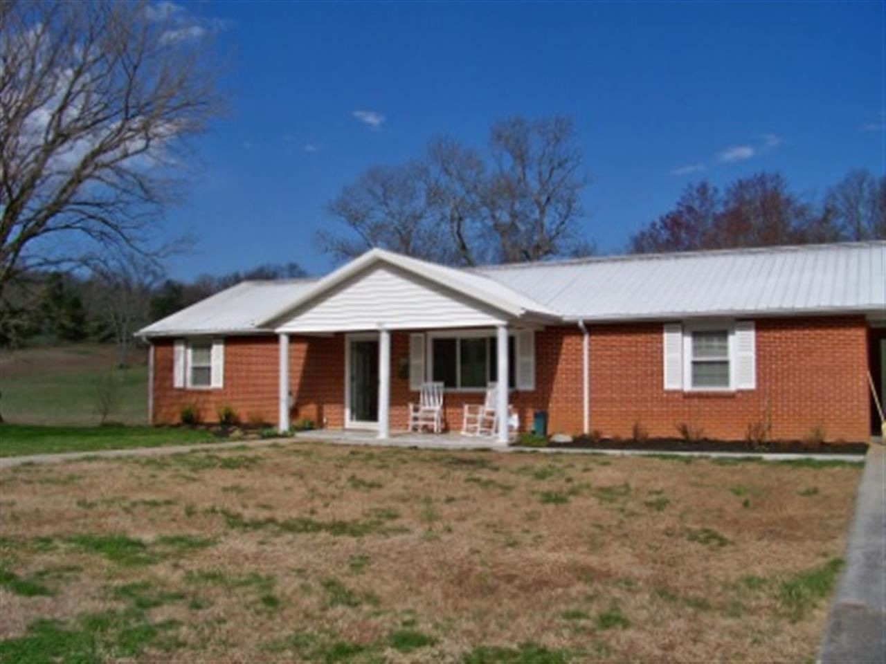 1618 Sweetwater Road Philadelphia, TN 37846 - Photo 1 of 1 a front view of house with yard and trees in the background