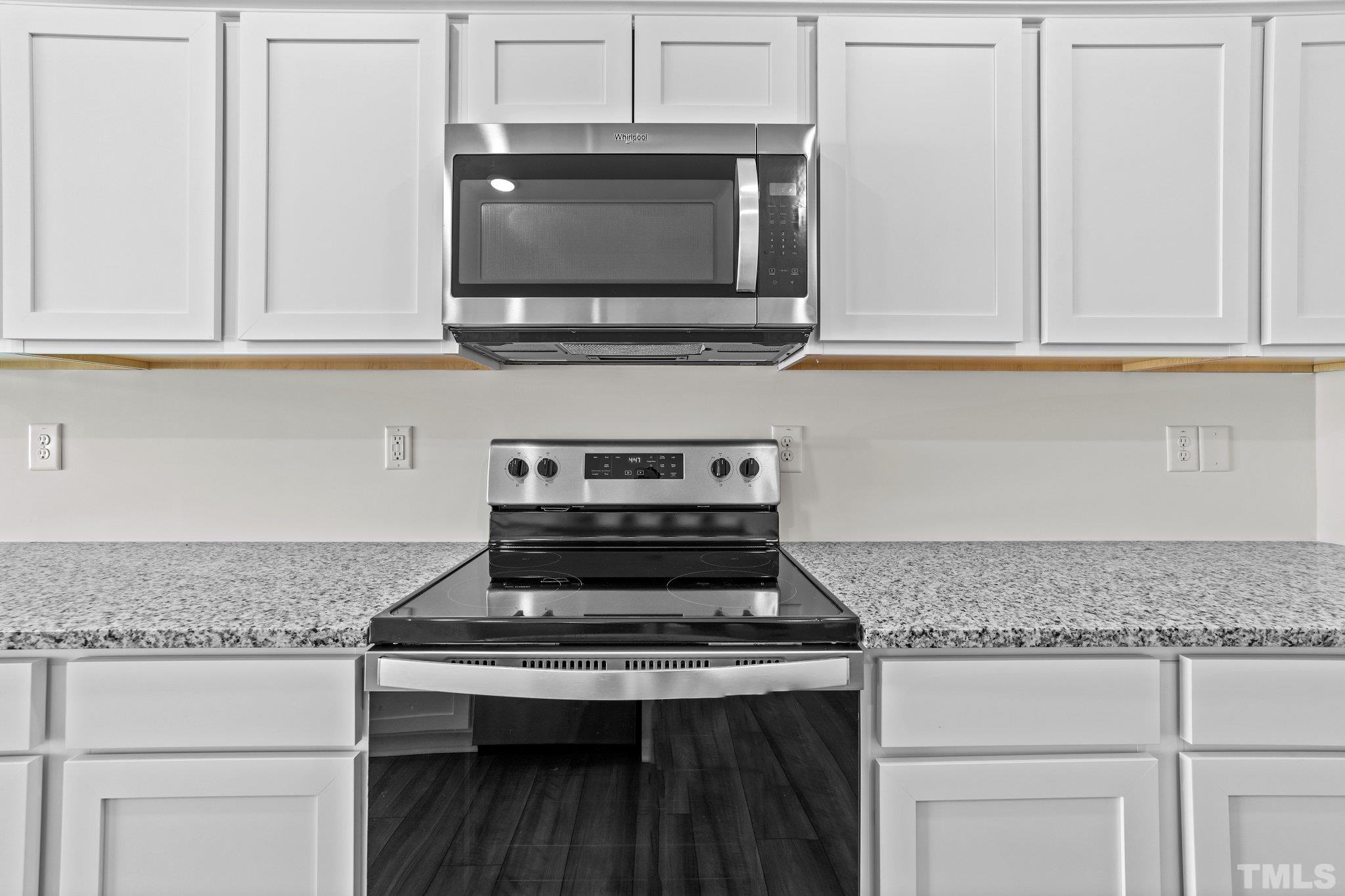 200 Miles Drive Pikeville, NC 27863 - Photo 12 of 34 a kitchen with granite countertop a stove and a microwave