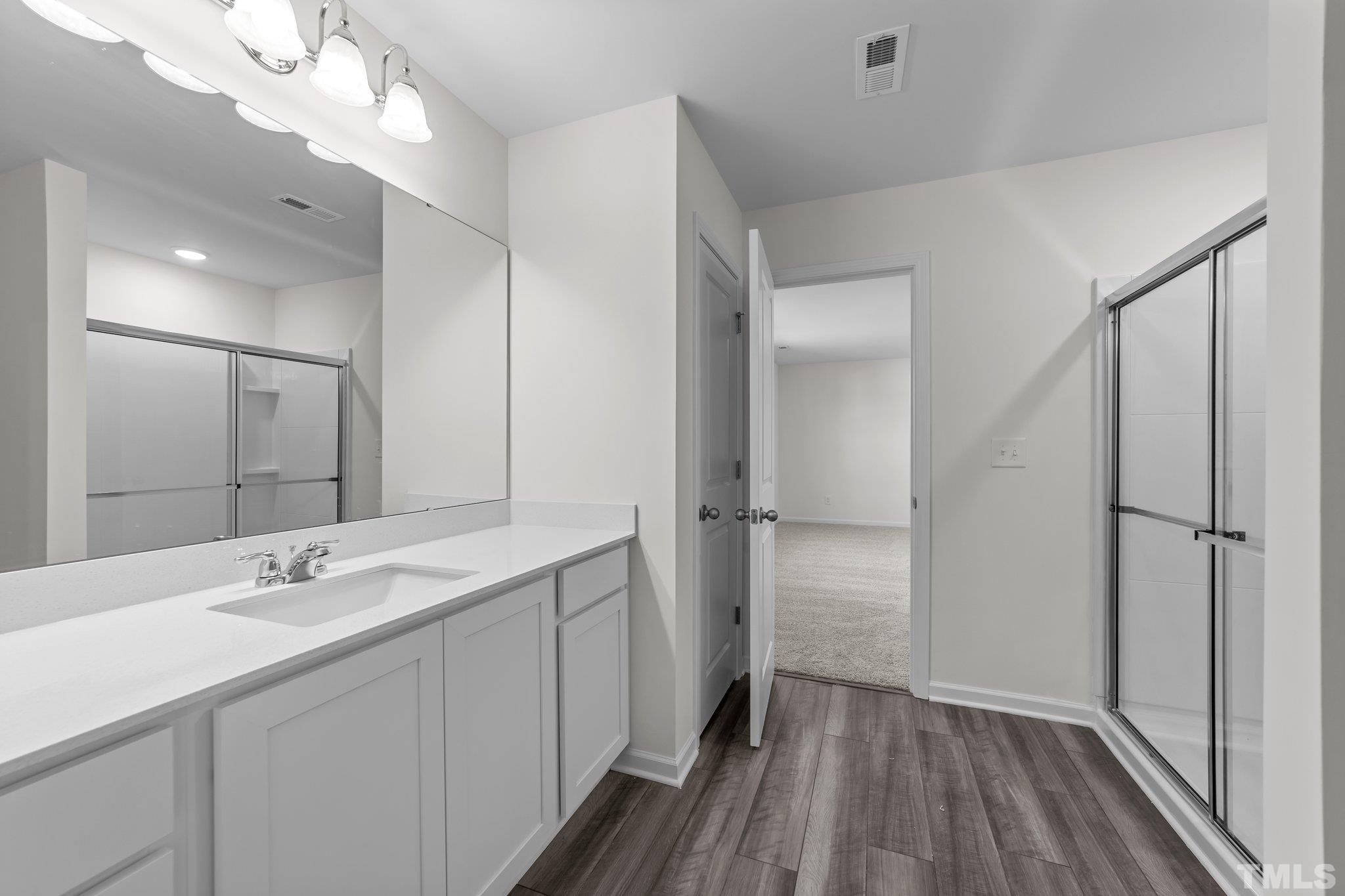 200 Miles Drive Pikeville, NC 27863 - Photo 23 of 34 a bathroom with a double vanity sink a mirror and a shower