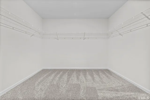a view of a room with an empty space and wooden floor