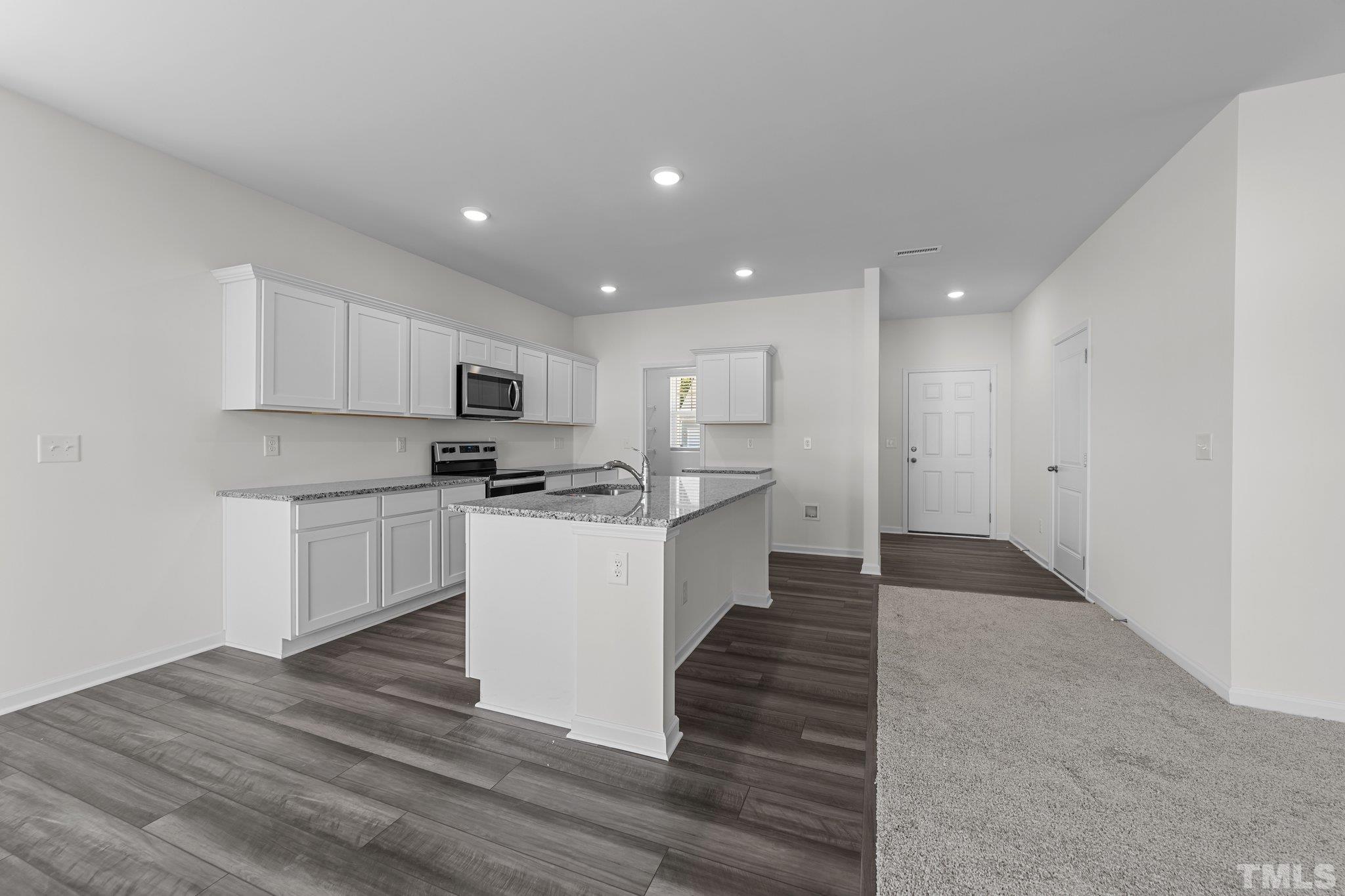 200 Miles Drive Pikeville, NC 27863 - Photo 7 of 34 a kitchen with a refrigerator and white cabinets