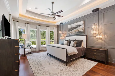 a spacious bedroom with a bed and glass window
