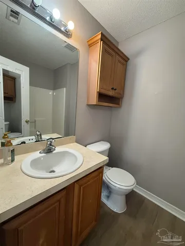 a bathroom with a sink a toilet and mirror