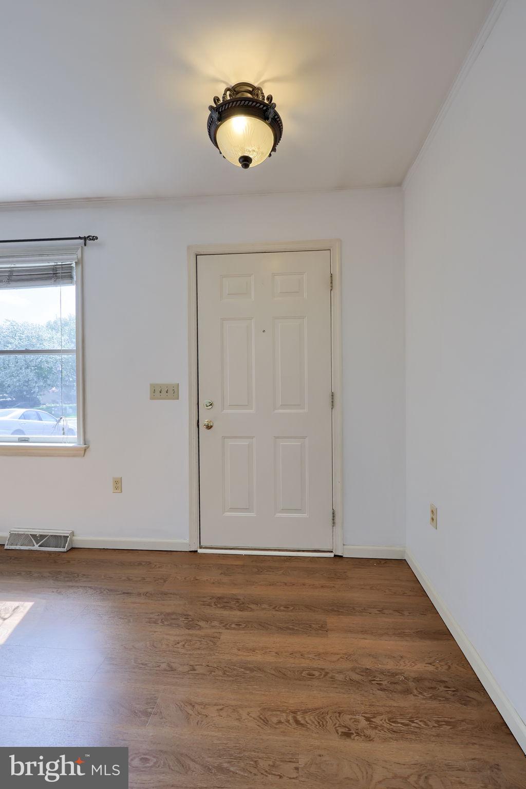 142 Palm Lane Lebanon, PA 17042 - Photo 5 of 38 an empty room with wooden floor and windows