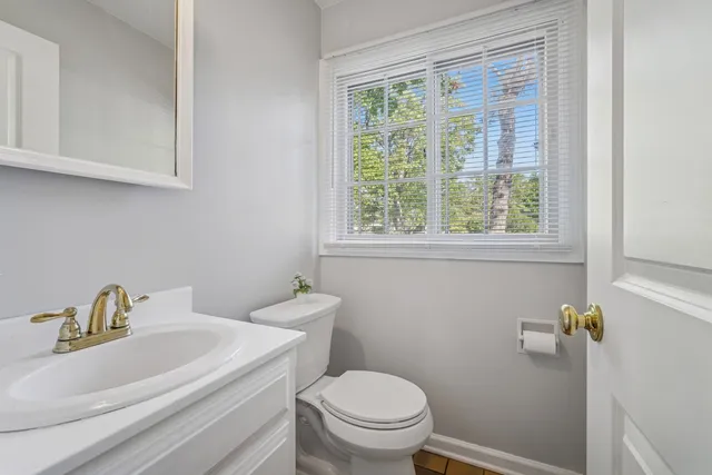 a white toilet sitting next to a bathroom sink