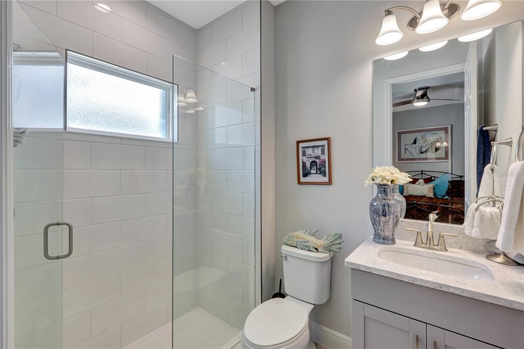 6219 Golden Nettle Drive Apollo Beach, FL 33572 - Photo 16 of 37 a bathroom with a granite countertop sink mirror vanity and toilet