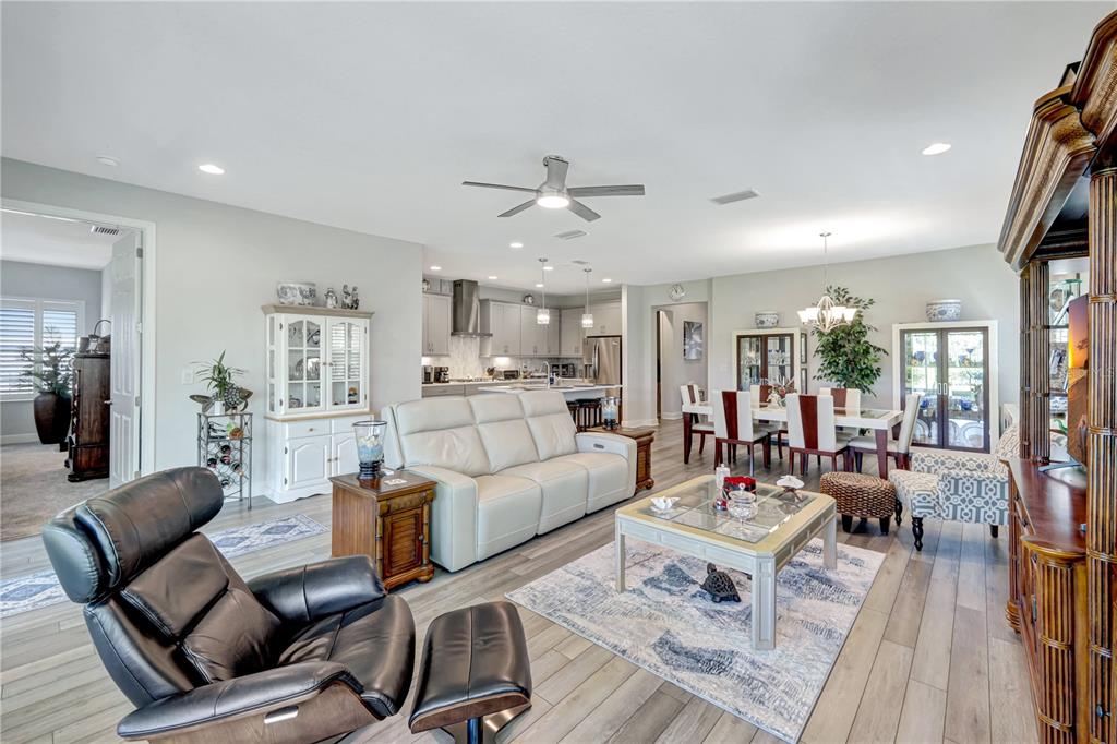 6219 Golden Nettle Drive Apollo Beach, FL 33572 - Photo 20 of 37 a living room with furniture or couches and a dining table with wooden floor