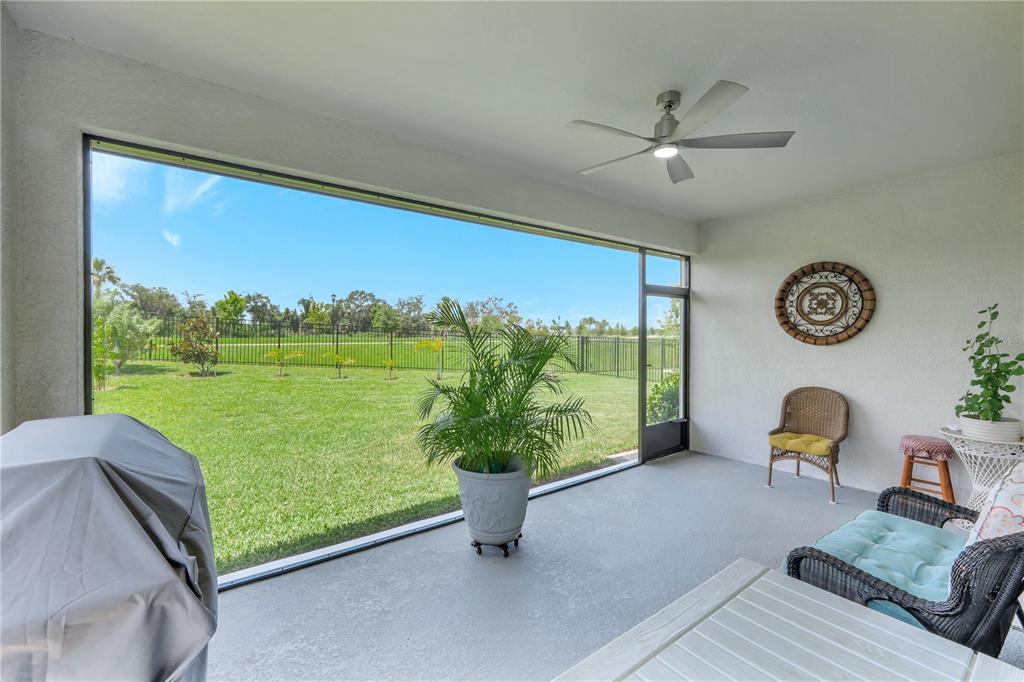 6219 Golden Nettle Drive Apollo Beach, FL 33572 - Photo 23 of 37 a living room with furniture floor to ceiling window and a table