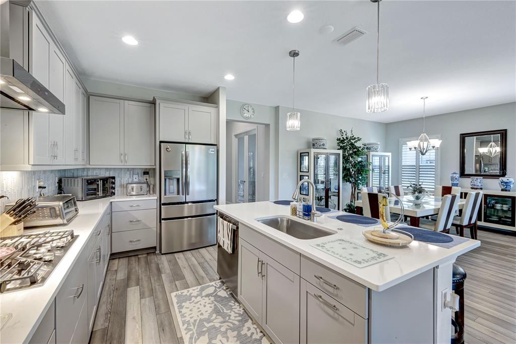 6219 Golden Nettle Drive Apollo Beach, FL 33572 - Photo 4 of 37 a kitchen with a sink stove and refrigerator