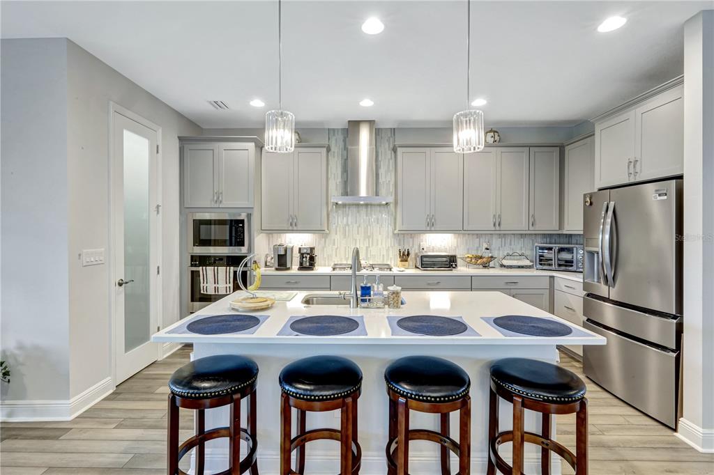 6219 Golden Nettle Drive Apollo Beach, FL 33572 - Photo 8 of 37 a kitchen with stainless steel appliances granite countertop a dining table and chairs
