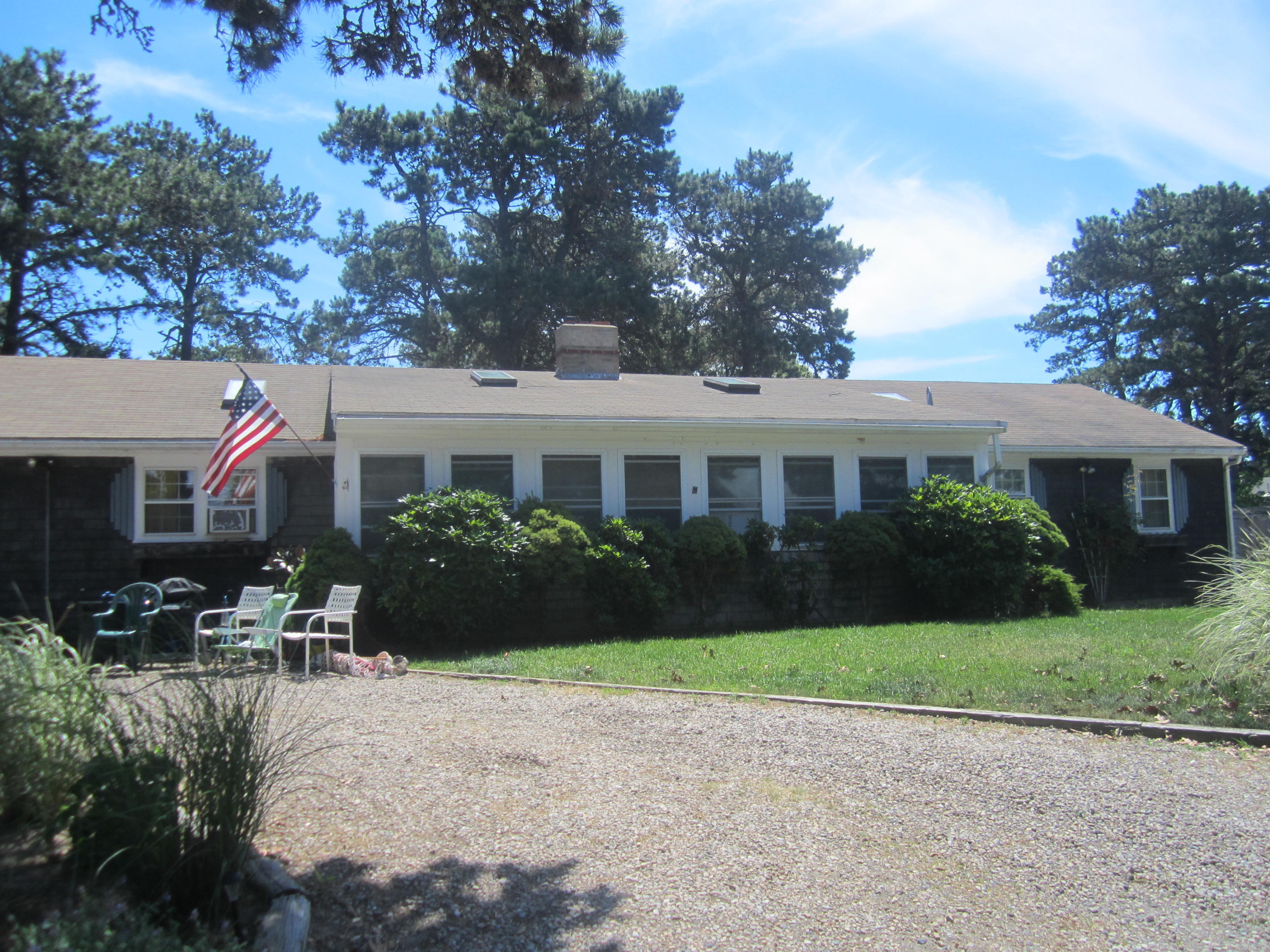 101 Lower County Road, Unit U1A Dennis Port, MA 02639 - Photo 3 of 10 a front view of house with yard and green space