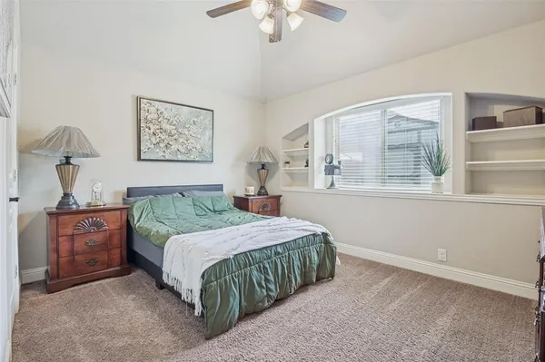 a bedroom with a large bed and a chandelier