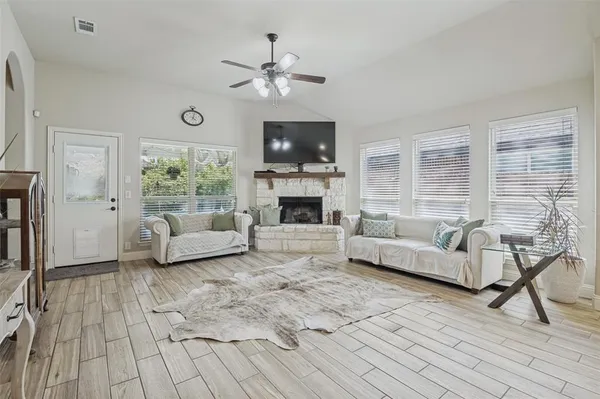 a living room with furniture and a fireplace