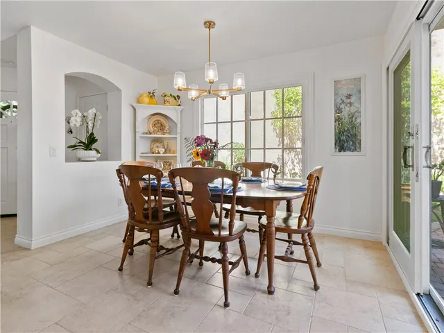 a view of a dining room with furniture and a chandelier