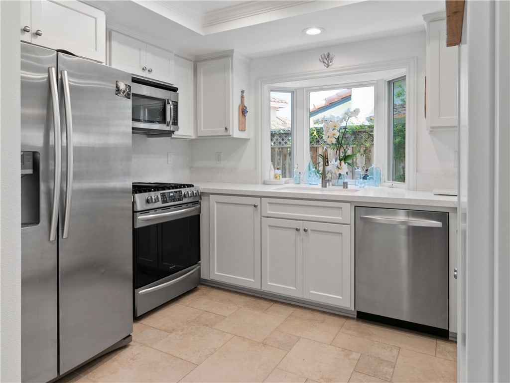24822 Cutter Laguna Niguel, CA 92677 - Photo 15 of 49 a kitchen with white cabinets and stainless steel appliances