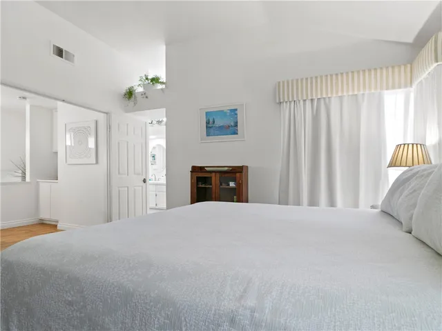 a bed room with a bed and a painting