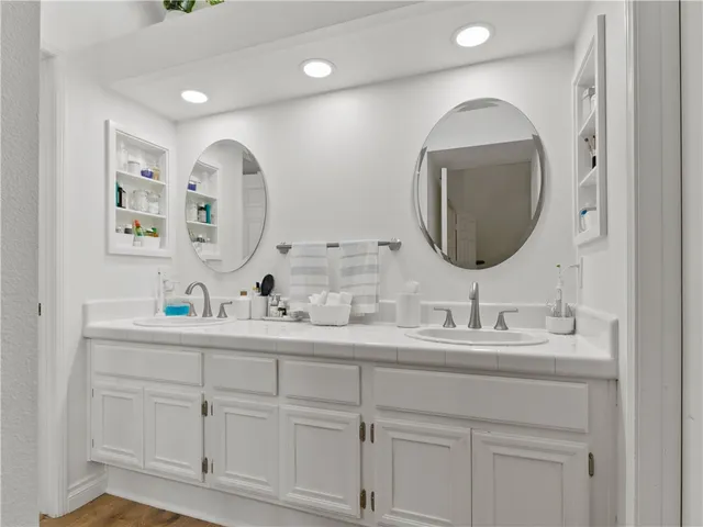 a bathroom with a double vanity sink and a mirror