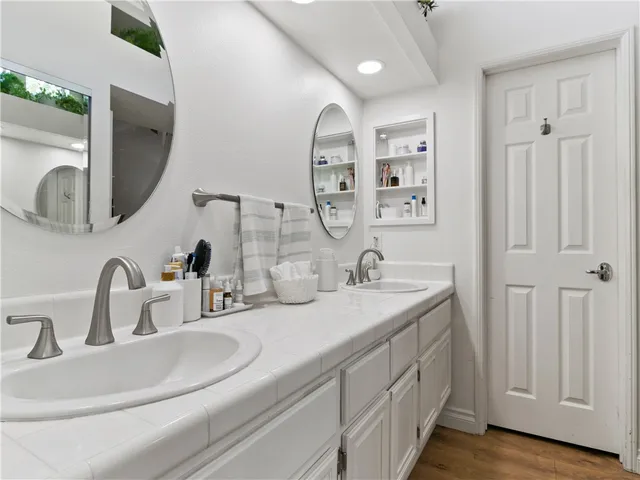 a bathroom with a double vanity sink and a mirror