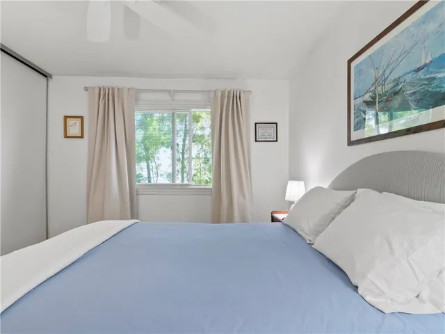 a bedroom with a large bed and a window