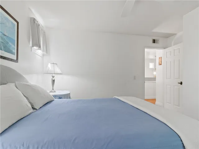 a bedroom with a bed and a lamp