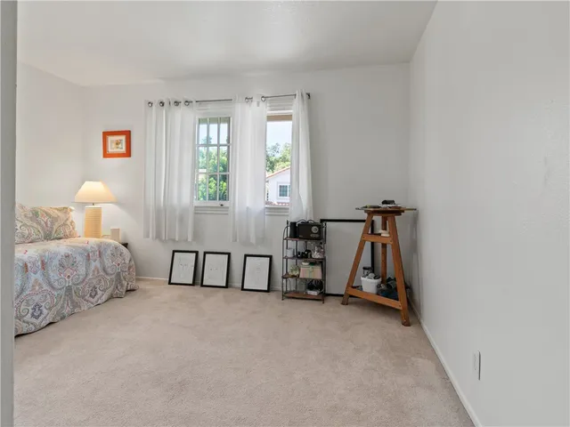 a bedroom with bed and a window