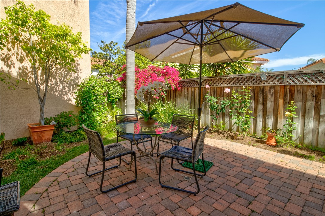 24822 Cutter Laguna Niguel, CA 92677 - Photo 41 of 49 a view of patio with chairs and table under an umbrella