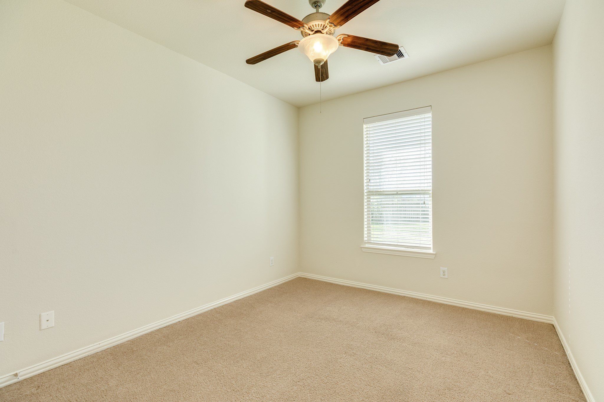 13417 Star Creek Lane Rosharon, TX 77583 - Photo 23 of 41 Secondary bedroom faces the side of the home, carpet, ceiling fan.