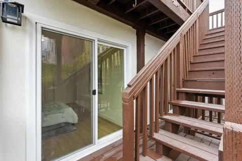 a view of staircase with large window and wooden floor