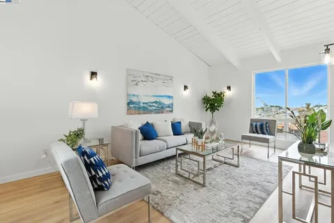 a living room with furniture potted plant and a wooden floor