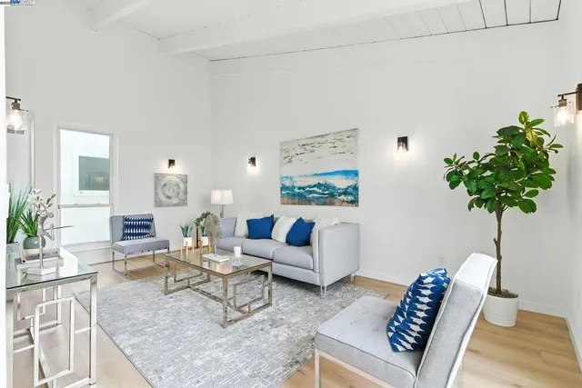 a living room with furniture and a potted plant