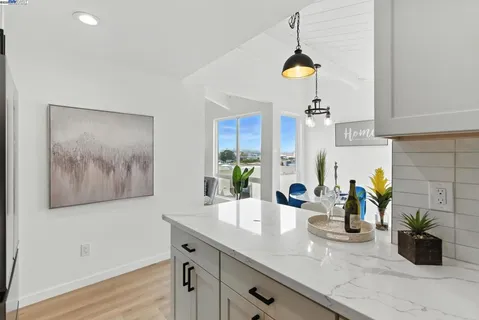 a kitchen with a sink and a chandelier