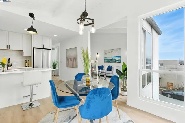 a view of a dining room with furniture a chandelier and wooden floor