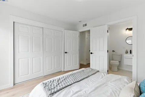 a bedroom with a bed and a toilet