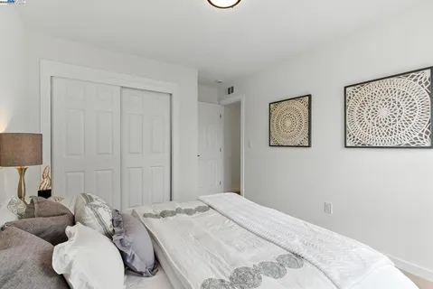 a bedroom with bed and a couch