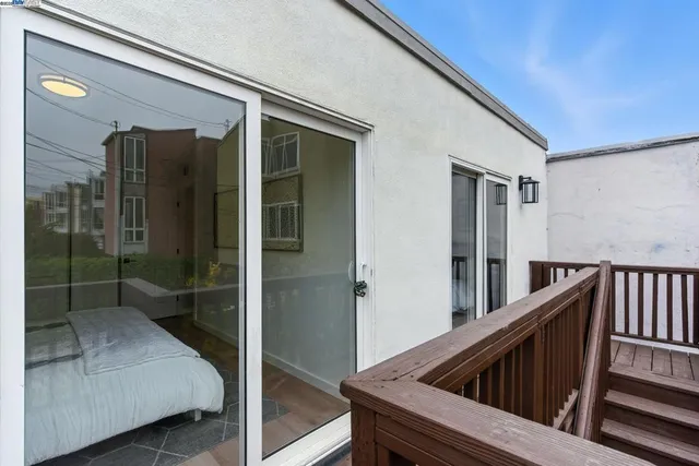 a view of balcony with wooden floor and outdoor seating