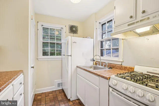 a bathroom with a granite countertop sink