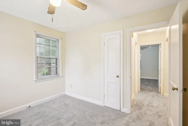 a bathroom with a toilet a sink and a window