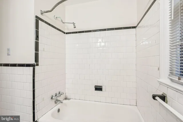 a bedroom with bed and window