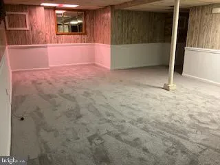 a view of an empty room with kitchen