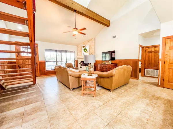 a living room with furniture and a floor to ceiling window