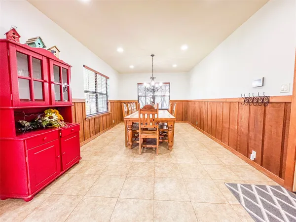 a kitchen with stainless steel appliances kitchen island granite countertop a table and chairs in it