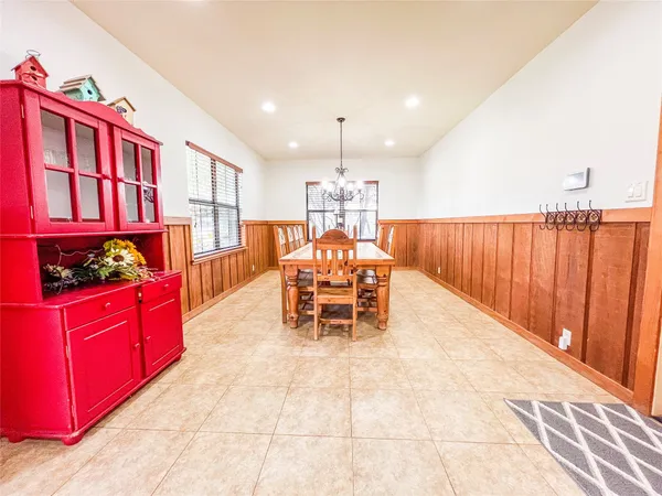 a kitchen with stainless steel appliances granite countertop a stove a sink dishwasher with a dining table and chair